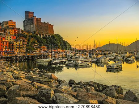 Cliff Of Lerici Italian City At Sunset. Gulf Of Poets And San Giorgio Castle On The Background At In