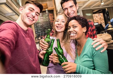 Multiracial Friends Taking Selfie And Drinking Beer At Fancy Brewery Restaurant - Friendship Concept
