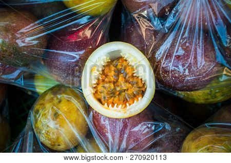 Close Up Passion Fruit Ripe Rip On Plastic Bag Pack Background, Passiflora Edulis