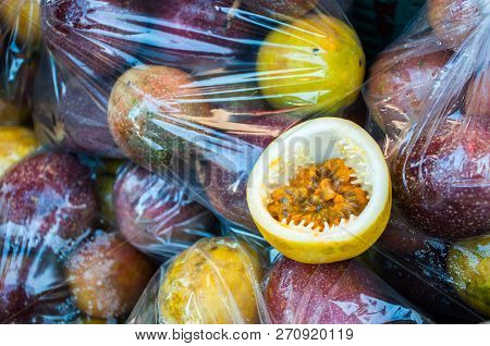 Close up Passion fruit ripe rip on plastic bag pack background, Passiflora edulis