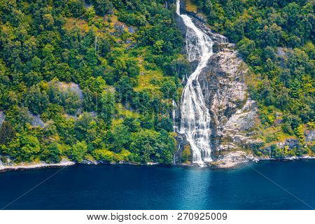 Breathtaking view of Sunnylvsfjorden fjord and famous Seven Sisters waterfalls, near Geiranger village in western Norway.