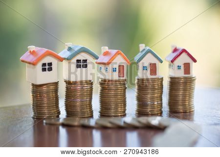 Mini House On Stack Of Coins,money And House,  Mortgage, Savings Money For Buy House And Loan To Bus