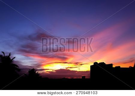 Sun Setting Over Sub-urban Bengaluru With The Buildings Rendered As Silhouette