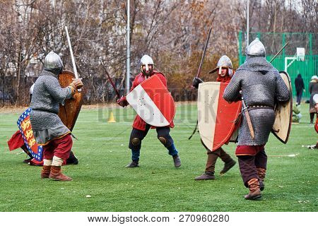 Moscow, Russia - November 17, 2018. Medieval Knights Fighting With Swords And Shields. Reconstructio