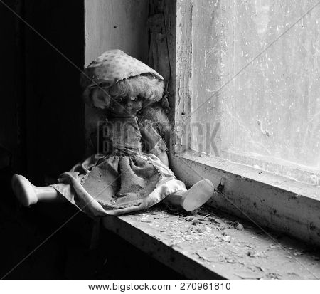 Doll On Windowsill In Abandoned Kindergarten In Destroyed Village Of Kopachi, Chernobyl Npp Exclusio
