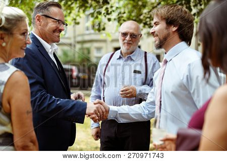 Men shaking hands at a party