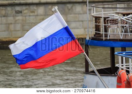 Waving Russian Flag On The Flagpole At The Stern Of A Pleasure Boat Closeup On A Background Of Moskv
