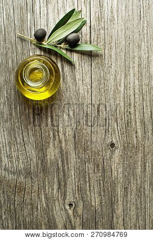Bottle Of Extra Virgin Healthy Olive Oil With Fresh Olives Close Up