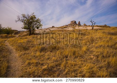 Uchisar, Cappadocia, Turkey: The Road On The Field Goes To The City And The Fortress Of Uchisar. Roc