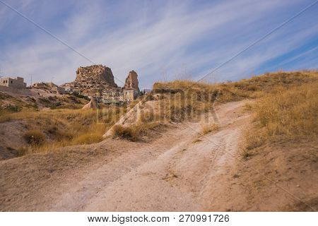 Uchisar, Cappadocia, Turkey: The Road On The Field Goes To The City And The Fortress Of Uchisar. Roc