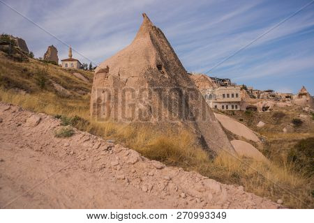 Uchisar, Cappadocia, Turkey: The Road Leads To The City And Uchisar Fortress. Rock Houses And Church