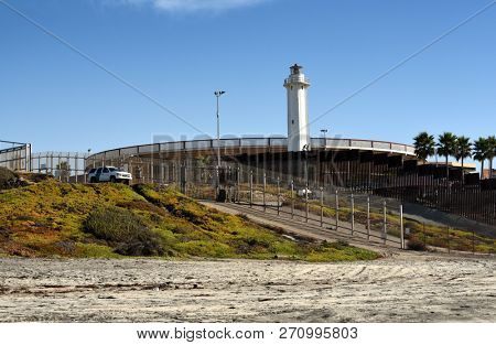 SAN YSIDRO, CALIFORNIA - NOVEMBER 26, 2018: The USA Mexico Border Wall and Border Patrol Vehicle from Imperial Beach looking towards the International Friendship Park, Tijuana.