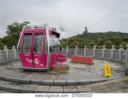 Ngong Ping, Hong Kong, May 2018 - View Of A Ngong Ping 360 Cable Car With The Tian Tan Big Buddha In