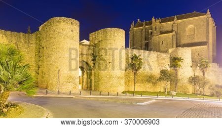 Night View Of City Walls And Church Of The Holy Spirit. Ronda, Spain.