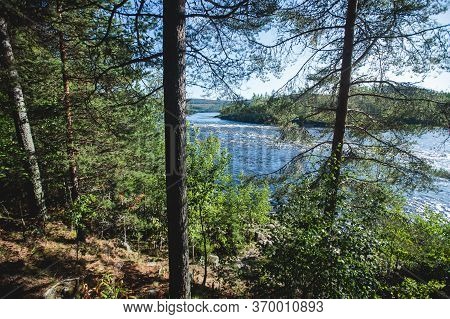 View Of Kalix River, Kalixalven, Overkalix Locality And The Seat In Norrbotten County, Sweden, With