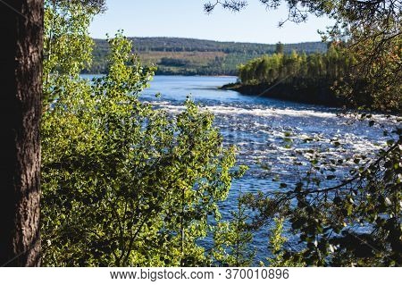 View Of Kalix River, Kalixalven, Overkalix Locality And The Seat In Norrbotten County, Sweden, With