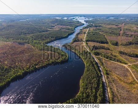View Of Kalix River, Kalixalven, Overkalix Locality And The Seat In Norrbotten County, Sweden, With