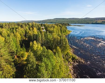 View Of Kalix River, Kalixalven, Overkalix Locality And The Seat In Norrbotten County, Sweden, With