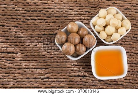 Organic Macadamia Nut On Wooden Table - Macadamia Integrifolia