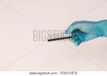 Closeup Man In Medical Latex Glove Hold Blank Credit Card In Hand Isolated On White Background. Male
