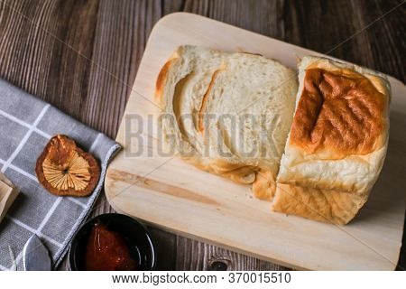 Close Up Fresh Homemade Loafs Bread And Sliced Bread On Cutting Board With Jam Strawberry On Wooden 