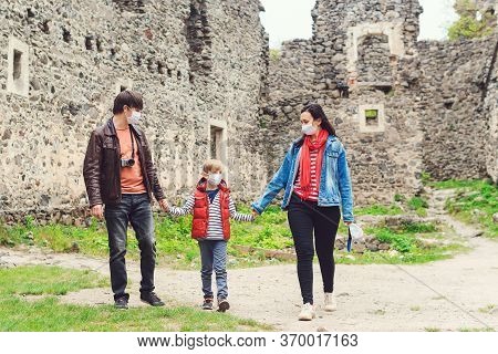 Family Trip To Old Castle Duric Pandemic. Parents With Son Wearing Face Masks Outdoors. Safety Mask 