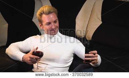 Youngman Talking The Phone At Home On Video Calls With Friends , Glasses Red Wine