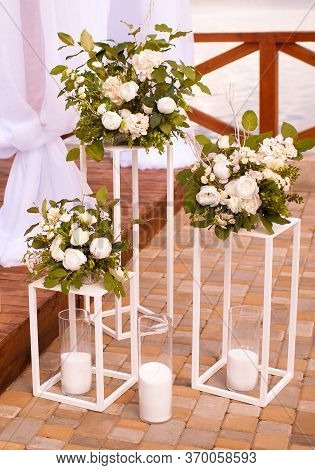 Beautiful Wedding Decor With White Flowers On Stands.