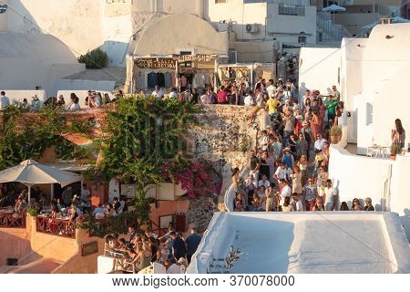 Santorini, Greece - July 18 2019: Beautiful Village Of Oia Crowded Full Of Tourists For The Sunset, 