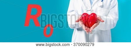 R Nought Theme With A Doctor Holding A Heart On A Blue Background
