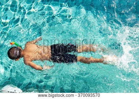 The Boy Is Very Happy To Swim In The Pool. Family Vacation Concept