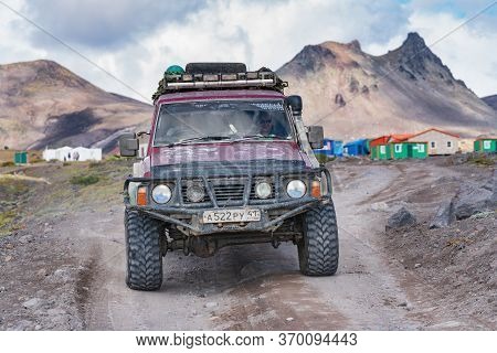 Japanese Sport Utility Vehicle Nissan Patrol Driving On Rocky Mountain Road On Background Volcano La