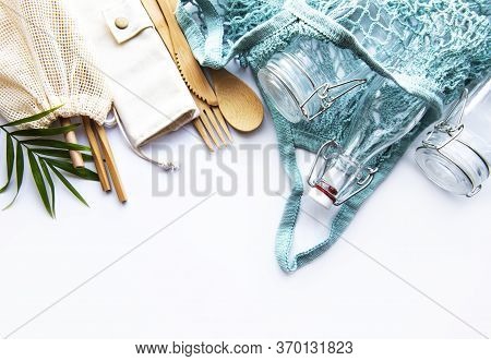 Cotton Bags, Net Bag With Reusable  Glass Jars, Bamboo And Wooden Cutlery On White Background. Zero 