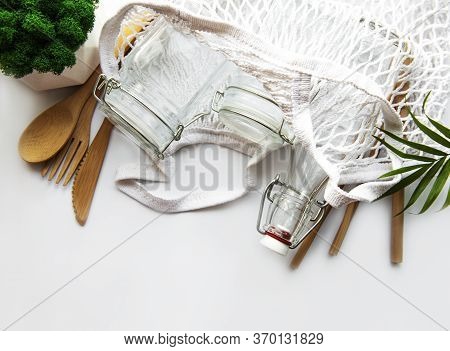 Cotton Bags, Net Bag With Reusable  Glass Jars, Bamboo And Wooden Cutlery On White Background. Zero 