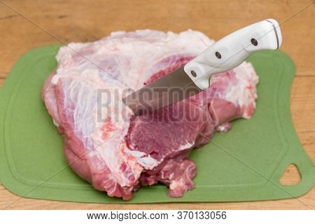 Slicing Pork Meat On Piece. Cooking Meat Dishes. Pork Meat On A Cutting Board