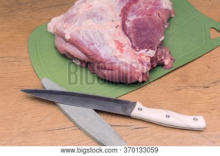 Slicing Pork Meat On Piece. Cooking Meat Dishes. Pork Meat On A Cutting Board