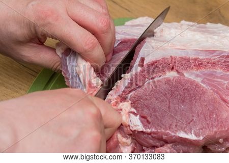 Slicing Pork Meat On Piece. Cooking Meat Dishes. Pork Meat On A Cutting Board