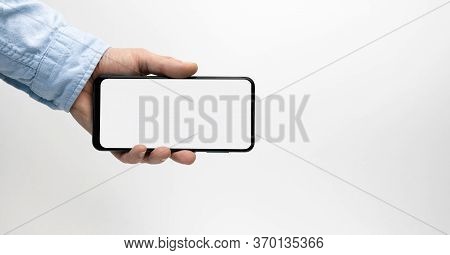 Male Hand Holding Smartphone With Blank Screen On White Background