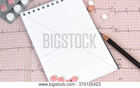 Empty Notebook Page On A Table With A Pills And Pencil, Medical Concept, Top View