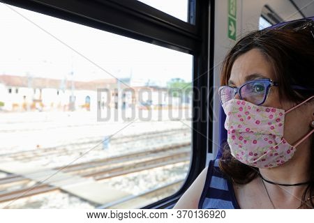 Pretty Woman With Surgical Mask On The Train