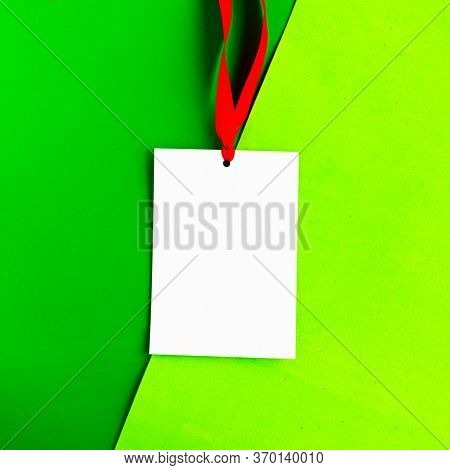 White Mockup Badge With Red Ribbon On Geometric Green Background. Copy Space For The Text. Minimal C