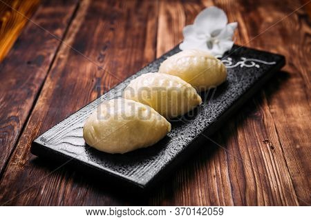 Side View On Korean Steamed Pjan-se Pigodi Pies With Cabbage And Meat , Horizontal