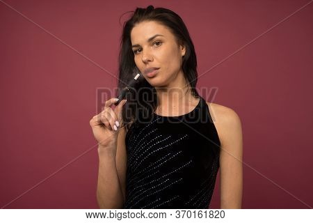 Tula, Russia - June 06 2020: Woman With E-cigarette. Heating Tobacco System Iqos Product Technologie