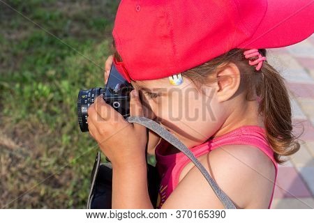 Little Girl Shooting Blog On Retro Photo Camera сlose Up.