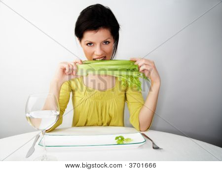 젊은 여 자가 물과 샐 러 리와 그녀의 아침 식사
