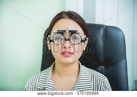Consultation With An Ophthalmologist. Young Asian Woman In Clinic Office.
