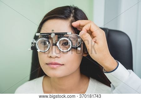 Consultation With An Ophthalmologist. Young Asian Woman In Clinic Office.