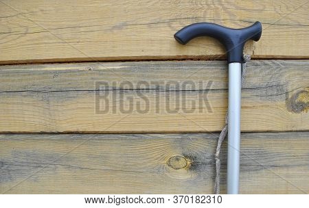 Close-up Of A Walking Stick On A Wooden Background.