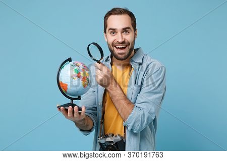 Excited Traveler Tourist Man In Yellow Clothes With Photo Camera Isolated On Blue Background. Passen