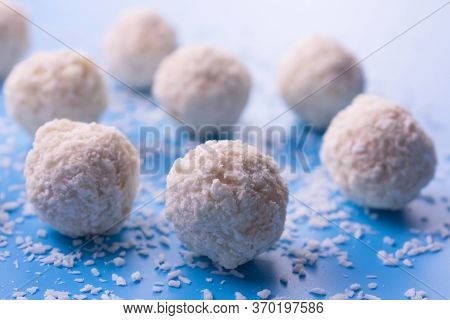 Coconut And White Chocolate Balls In The Form Of Balls On A Blue Background.